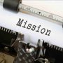 The word "Mission" on a piece of paper in a typewriter